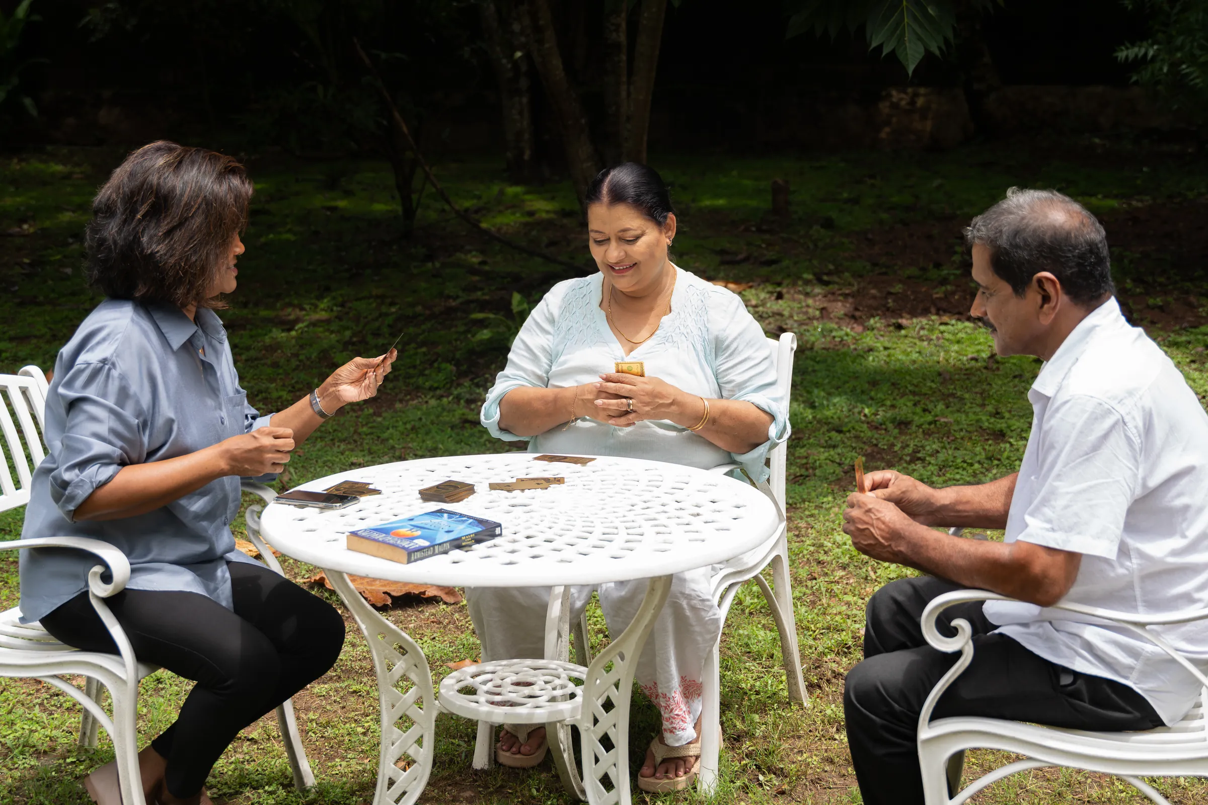 Residents playing cards together in the Golden Hands garden, Battaramulla